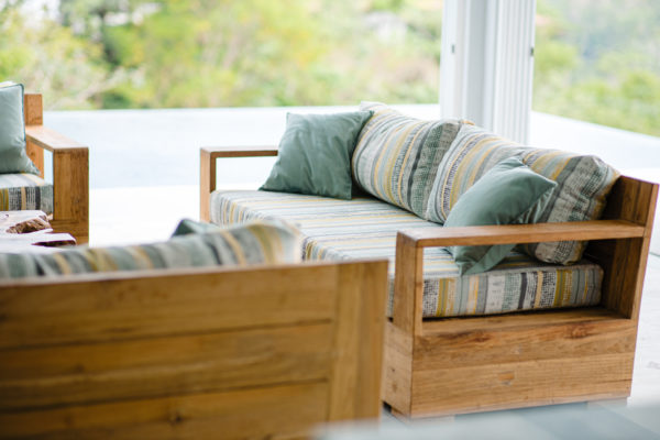 wooden sofa with accent pillows at villa costa vida