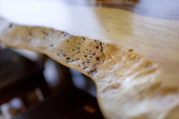 Closeup of the edge of the wooden dining table